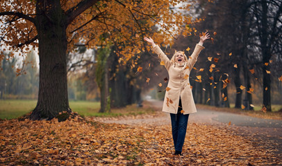 Senior woman in park in autumn