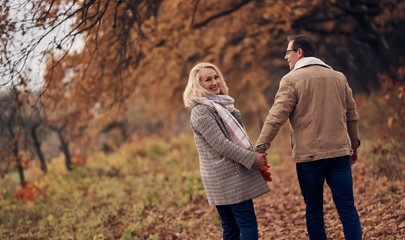 Senior couple in park in autumn