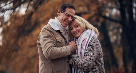 Senior couple in park in autumn