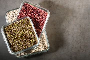 White beans, red beans mung bean in glass bowls on a dark background. Eco friendly, plastic free items.