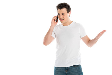 confused handsome man talking on smartphone isolated on white