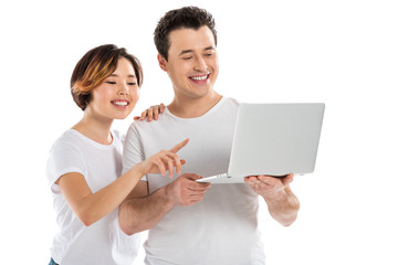 smiling young couple using laptop isolated on white