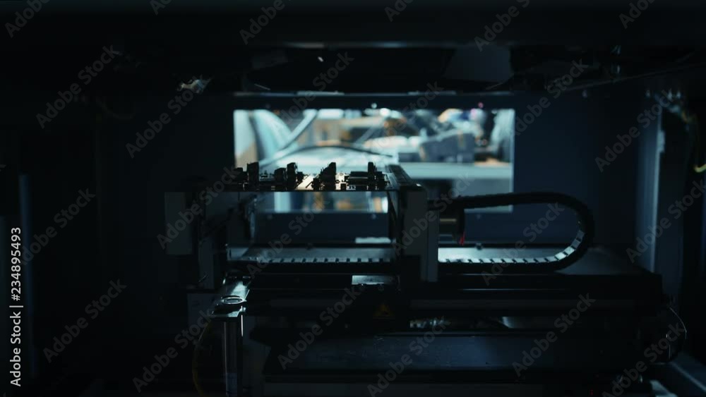Poster automated robotic industrial equipment is testing electronic printed circuit board with light and la