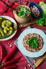 Lobio - traditional Georgian dish with red beans, cilantro, ajika spice served with pickles vegetables. Vegan vegetarian healthy food
