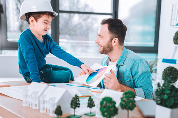 Cheerful kid pointing at the picture