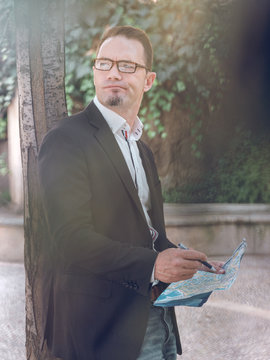 Businessman making notes on map