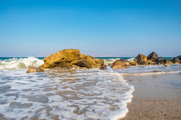 Quiet Wave And Foam Around Formation Of Rocks