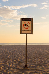 No swimming sign on the beach
