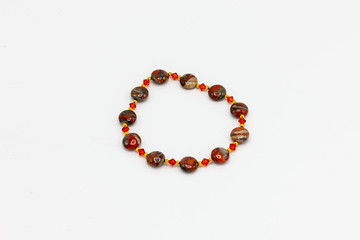multiple colored and sized beads bracelet on white background