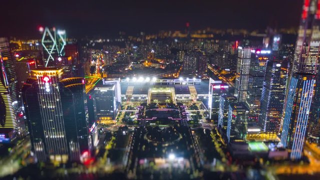 night time illuminated shenzhen city famous exhibition center aerial panorama 4k tilt shift timelapse china
