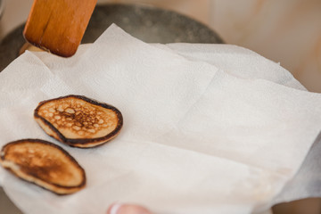 Fry fritters at home in the pan. Cooking pastries. Stand near the stove. View from above.