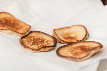 Fry fritters at home in the pan. Cooking pastries. Stand near the stove. View from above.