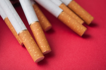 closeup of cigarettes on red background