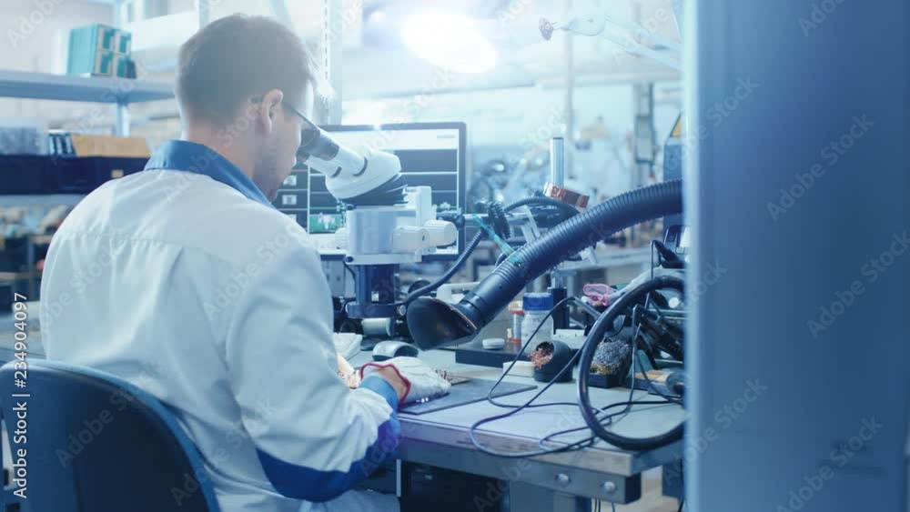 Aufkleber electronics factory worker in white work coat inspects a printed circuit board through a digital mic