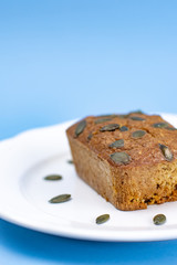 Gluten-Free pumpkin bread with pumpkin seed in white plate.