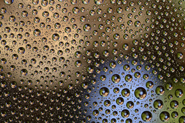Fototapeta premium Colored Water Drops on a smooth glass surface
