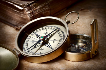 Fototapeta na wymiar compasses and book on the table