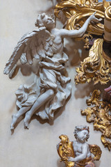 PRAGUE, CZECH REPUBLIC - OCTOBER 12, 2018: The carved polychrome baroque statue of angel from the side altar in St. Francis of Assisi church by  M. V. Jäckel a J. K. Liška. (17. - 18. cent.).