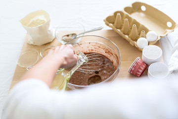 Cooking Christmas chocolate muffins. Mixing ingredients for brownies, cupcakes, pancakes. Woman...