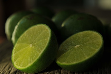 lime slices on wooden table. Detox diet, limes Backgrounds, Close up shot, fruit macro photography