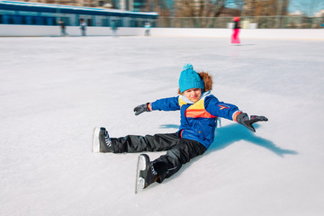 Fototapeta na wymiar little boy enjoy skating on ice in winter nature