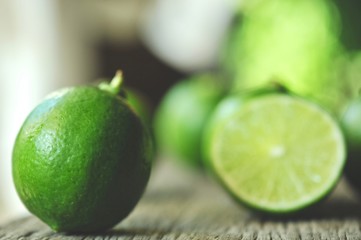 limes slices on wooden table. Detox diet, fresh lime Background, Close up shot, fruit macro photography
