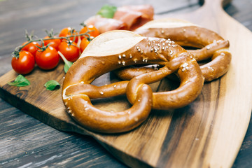 fresh delicious pretzel on wooden background concept
