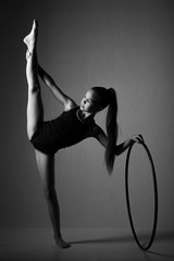 Teenager girl involved in rhythmic gymnastics with gymnastic hoop 