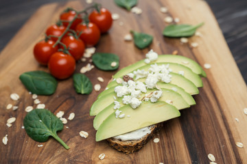 avocado sandwich with feta cheese on wooden table
