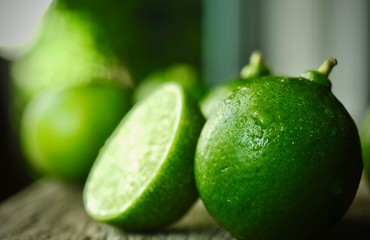 limes slices on wooden table. Detox diet, fresh lime Background, Close up shot, fruit macro photography
