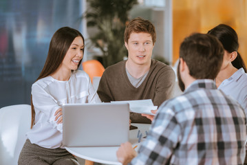 Professional four colleagues coming up with plan