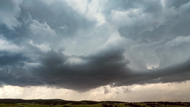 Time lapse of clouds building in storm over flat landscape.