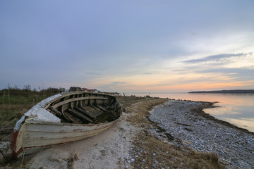 old wooden boat  lying at the beach, seascape solitude concept