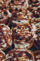 Homemade cinnamon rolls with pecan and caramel, close up