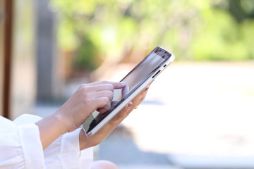 Soft focus of Woman hand holding tablet smart device with typing message or checking newsfeed on social networks, Communication technology concept