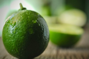 limes slices on wooden table. Detox diet, fresh lime Background, Close up shot, fruit macro photography