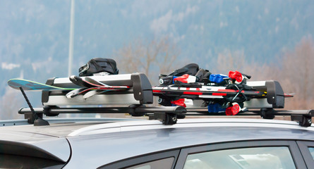 Luggage rack with ski and snowboard on a car