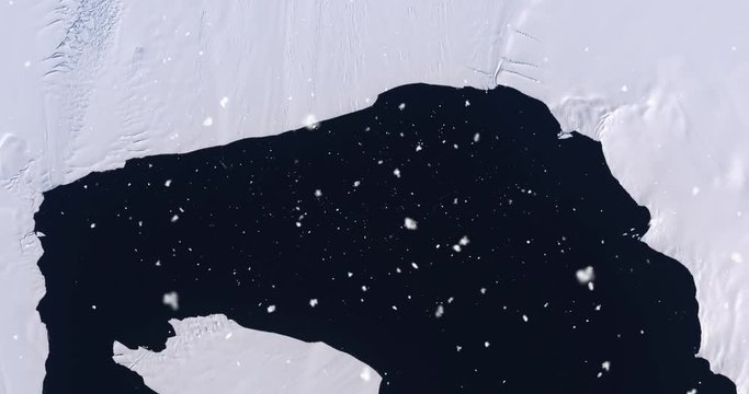 Vertical aerial ascent through light falling snow, over Pine Island Glacier, Antarctica. Elements of this image furnished by NASA. 