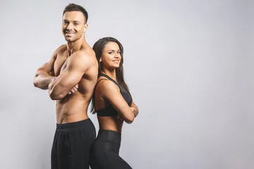 Poster Athletic man and woman isolated over white background. Personal fitness instructor. Personal training. © denis_vermenko