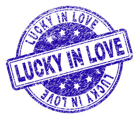 LUCKY IN LOVE stamp seal imprint with grunge texture. Designed with rounded rectangles and circles. Blue vector rubber print of LUCKY IN LOVE text with grunge texture.