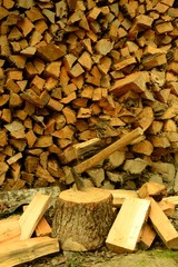 siekiera wbita w pień na tle porąbanego drewna © Agnieszka