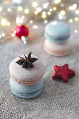 Colorful macaroons and brown anise. Red Christmas decoration.