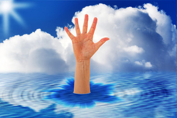 Outstretched hand sticks out of the water
