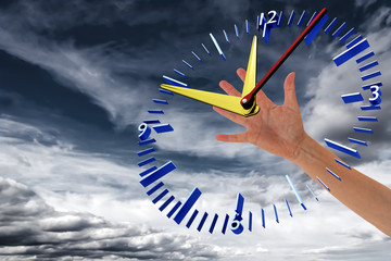 Hand reaches for clock