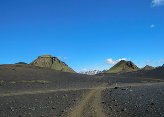 Walking path throw volcanic black sand desert landscape, Laugavegur Trail from Thorsmork to Landmannalaugar, Highlands of Iceland