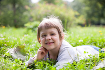  girl   resting on   green meadow