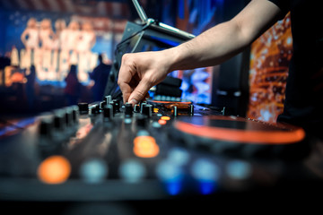 DJ sound equipment at nightclubs and music festivals, EDM, future house music and so on. Parties concept, sound technique. DJ playing on the best