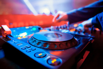 DJ sound equipment at nightclubs and music festivals, EDM, future house music and so on. Parties concept, sound technique. DJ playing on the best