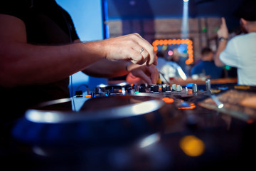DJ sound equipment at nightclubs and music festivals, EDM, future house music and so on. Parties concept, sound technique. DJ playing on the best