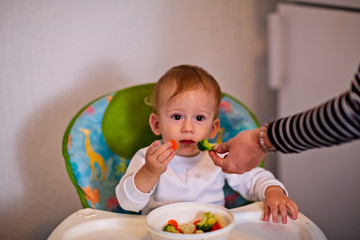 vegetable food for infant. Children eat vegetables. boy eating healthy vegetables.